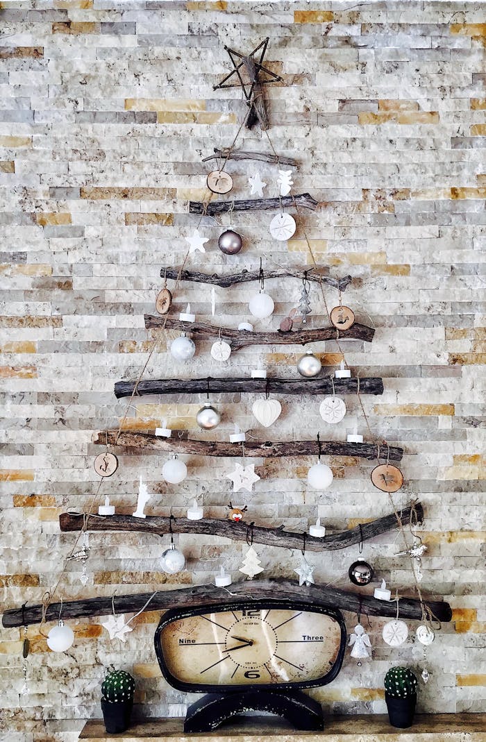 our-services-3 A unique DIY Christmas tree on a rustic brick wall, featuring natural materials and simple decorations.